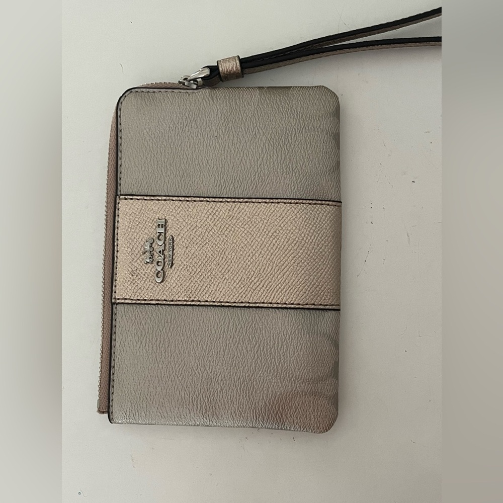Silver and rose gold authentic Coach wristlet/wallet.